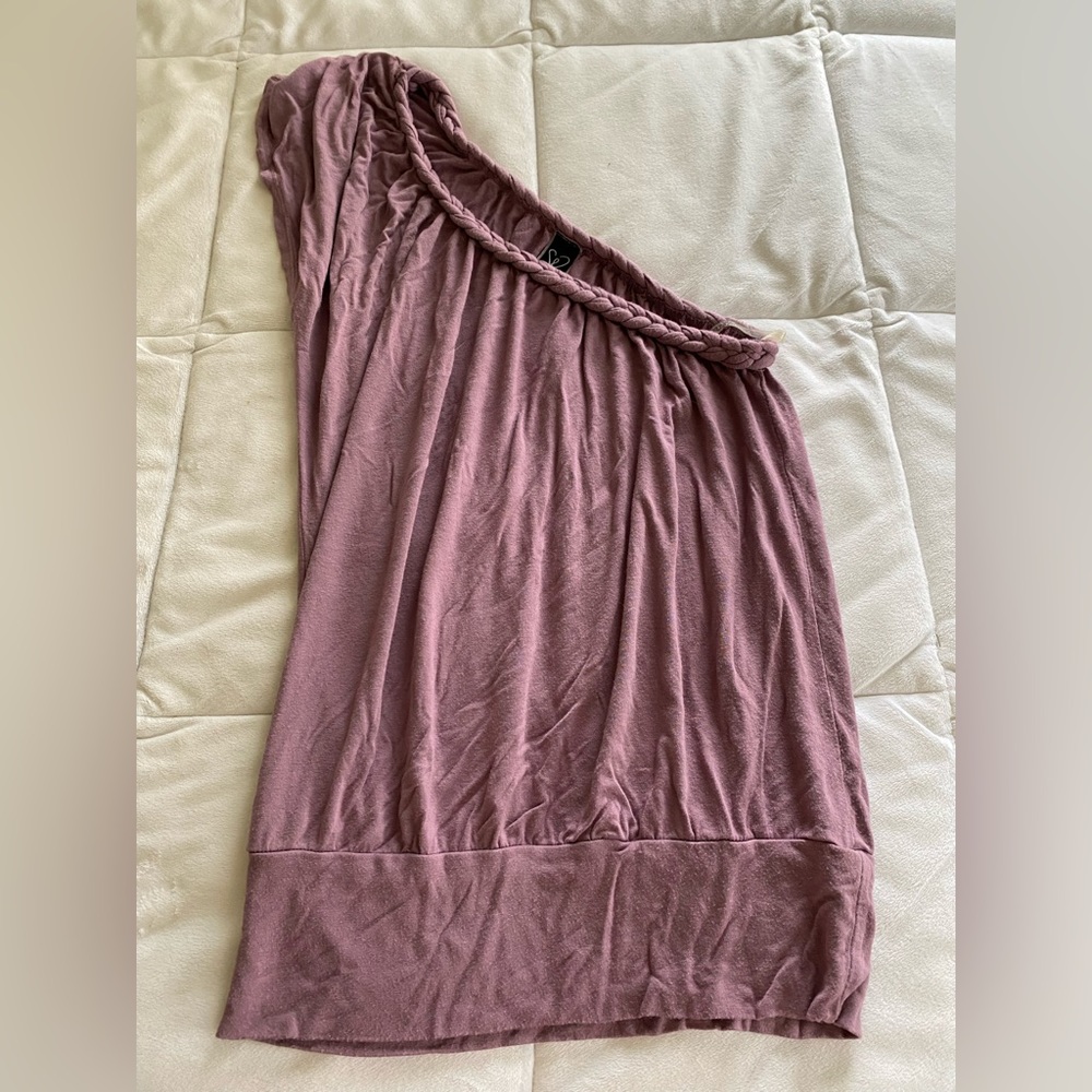 A cute purple one sleeved shirt that falls just below hip level